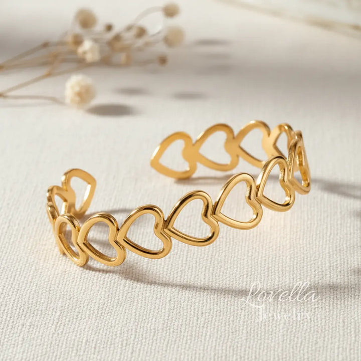 Gold heart-shaped bracelet on a light background