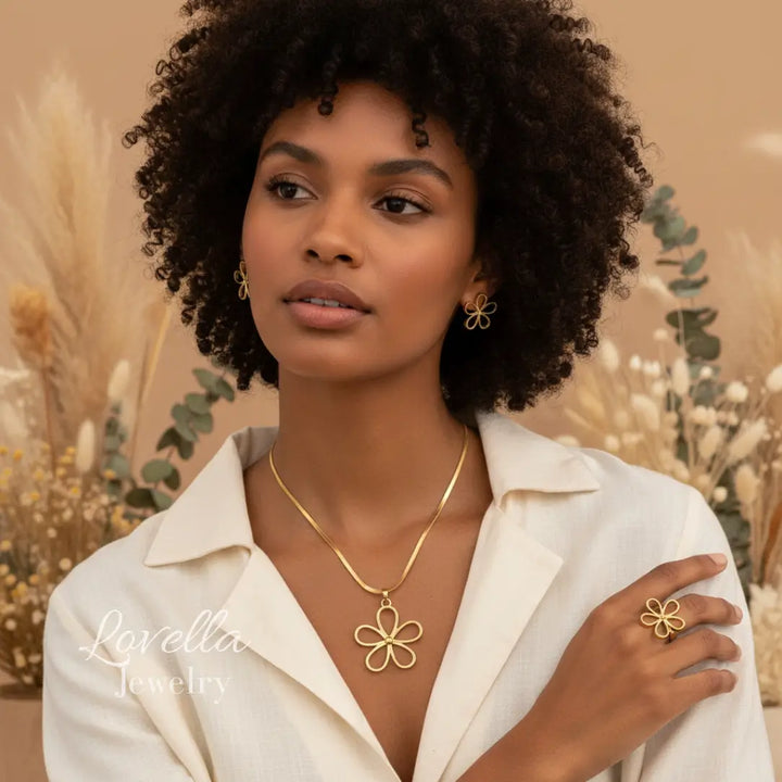 Woman wearing gold jewelry with a neutral background