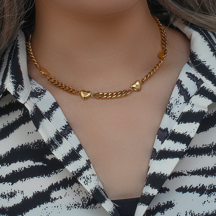 Collar de cadena con dijes dorados y motivos de corazones