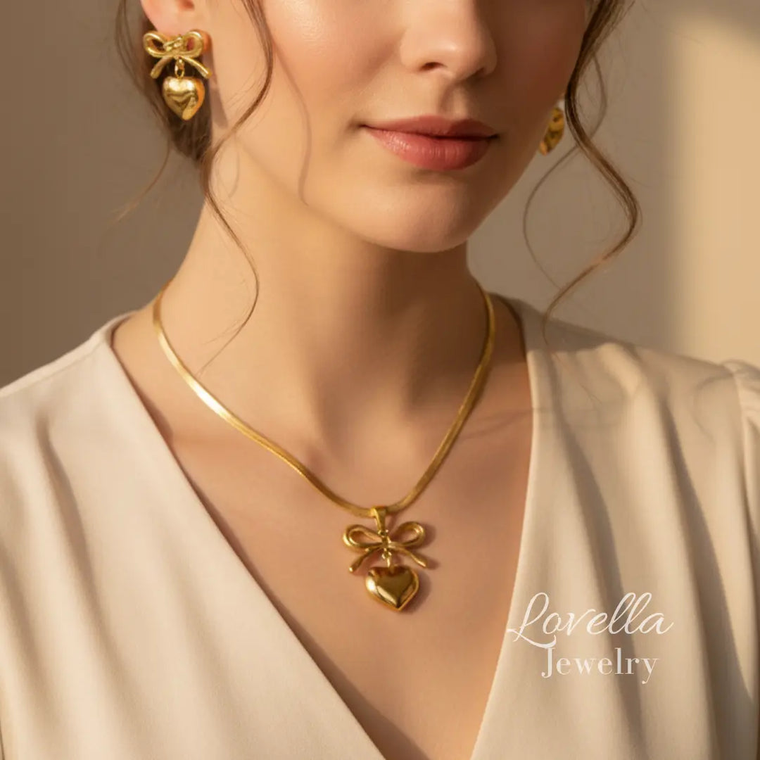 Woman wearing a gold necklace and earrings with 'Lovella Jewelry' branding.