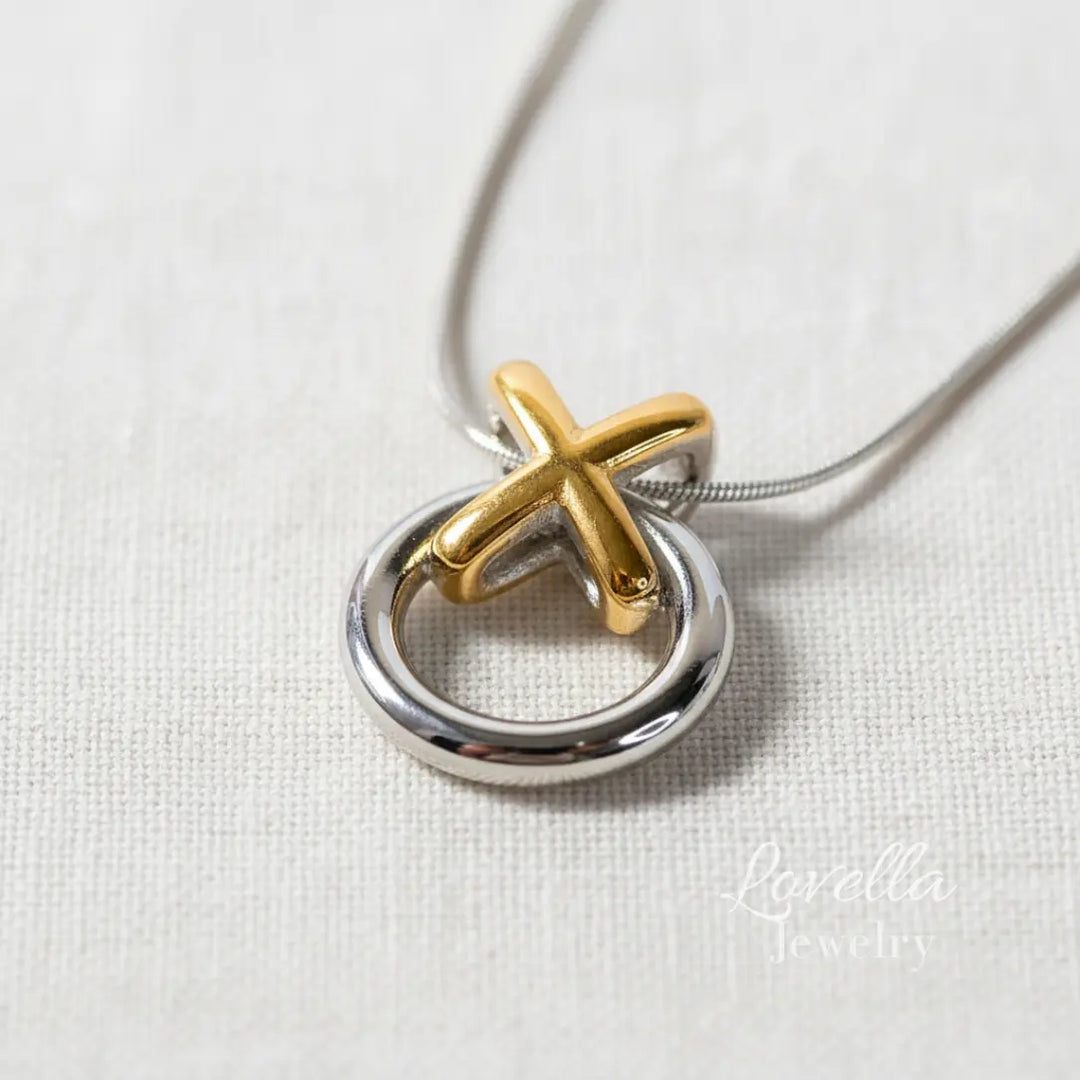 Gold and silver pendant on a white background