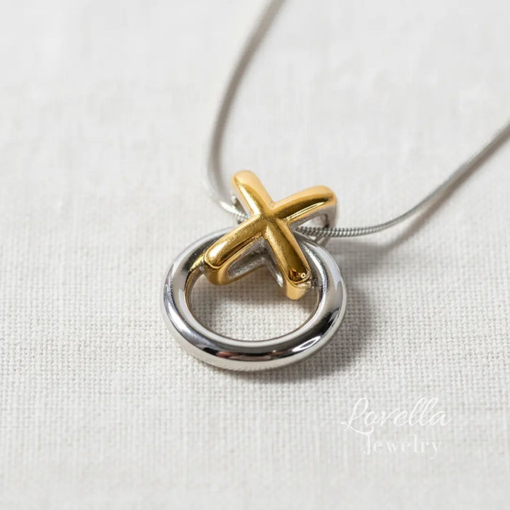 Gold and silver pendant on a white background