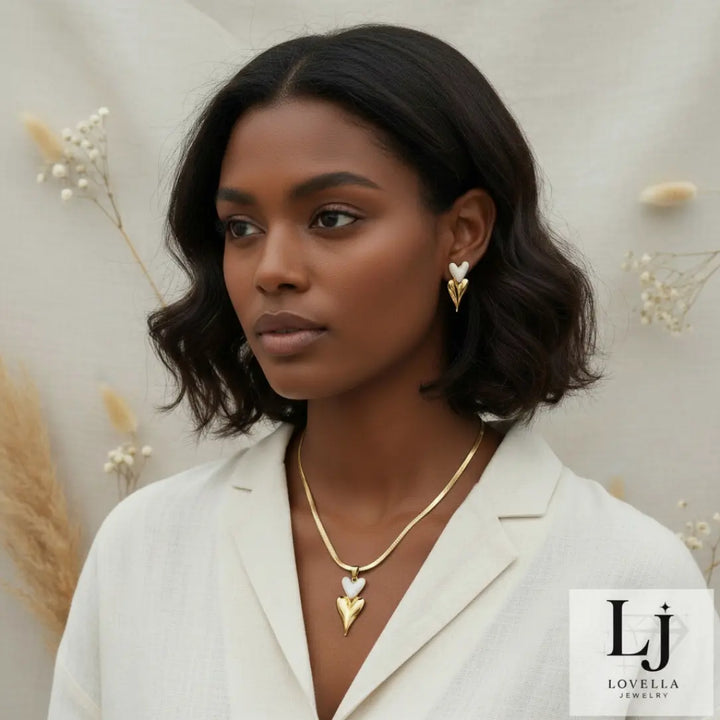 Woman wearing gold jewelry with a neutral background and Lovella Jewelry logo.