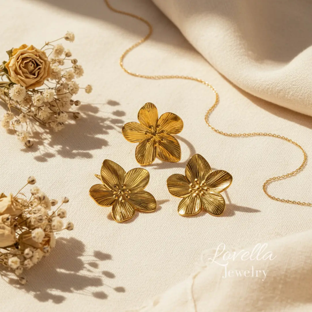 Gold floral earrings on a beige fabric background with 'Lavella Jewelry' branding.