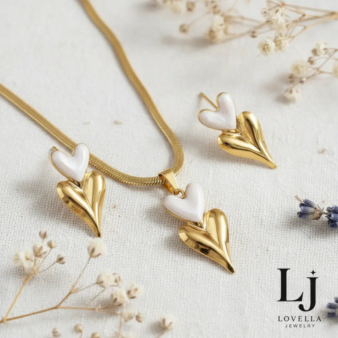 Gold and white heart-shaped jewelry set on a light background with Lovella Jewelry logo.