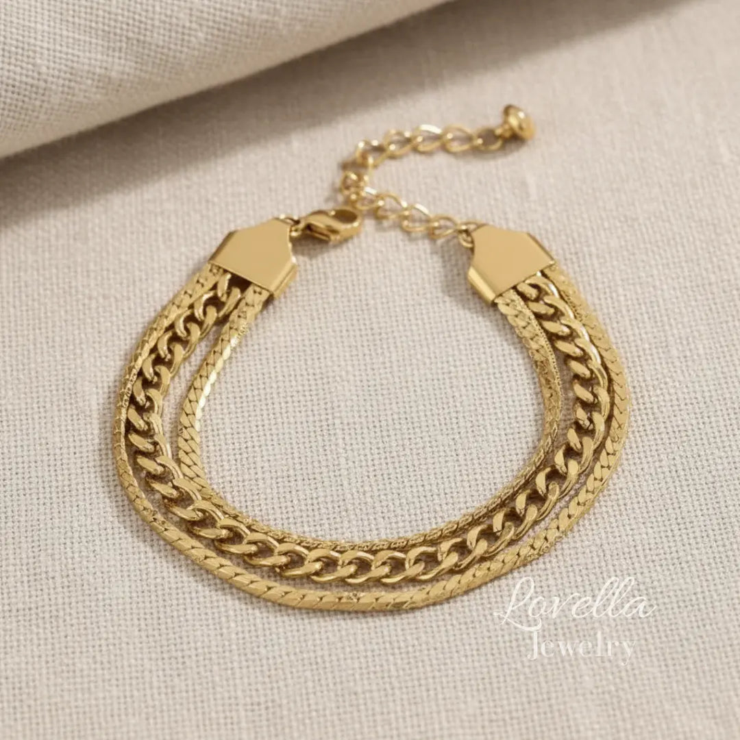 Gold chain bracelet on a beige fabric background
