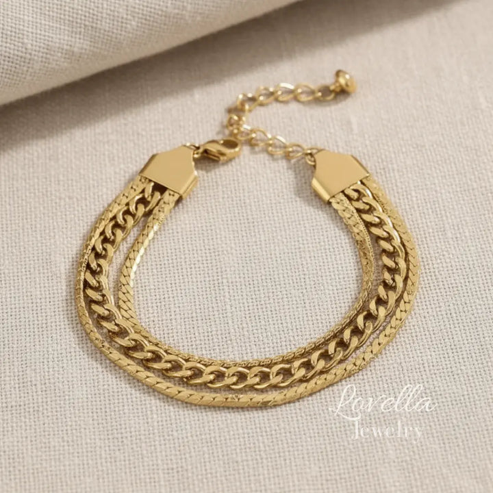 Gold chain bracelet on a beige fabric background