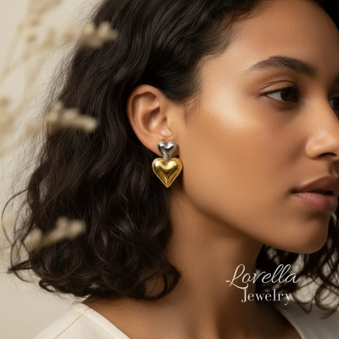 Woman wearing gold heart-shaped earrings with a blurred background