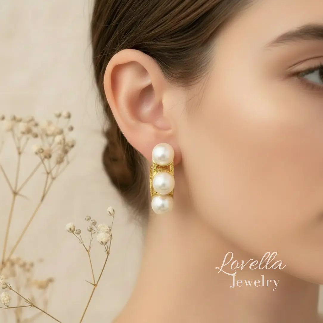 Pearl earring worn by a model with 'Lovella Jewelry' branding.