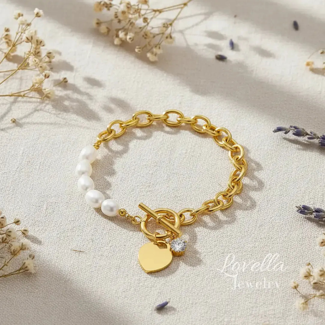 Gold bracelet with charms on a light fabric background