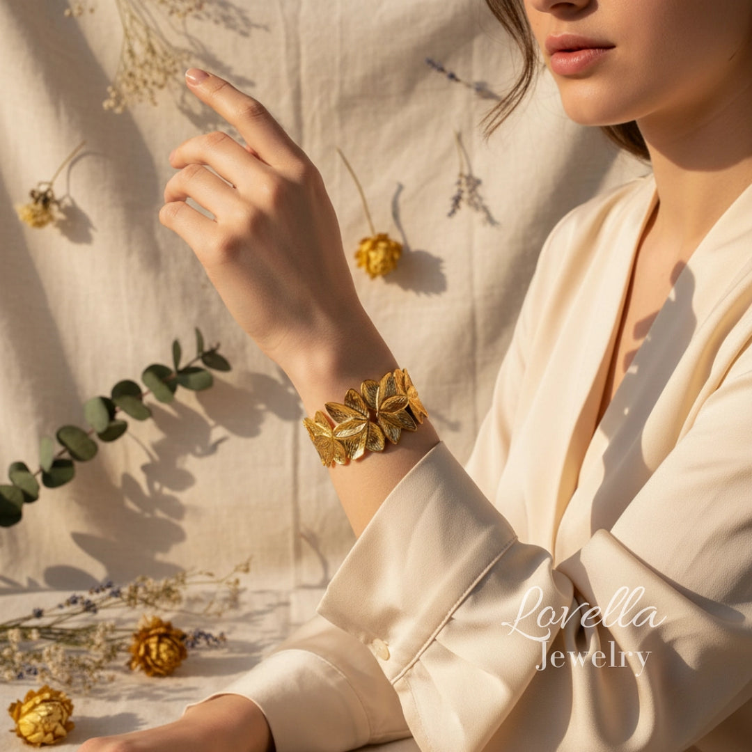 Woman wearing a gold bracelet with a soft, natural background
