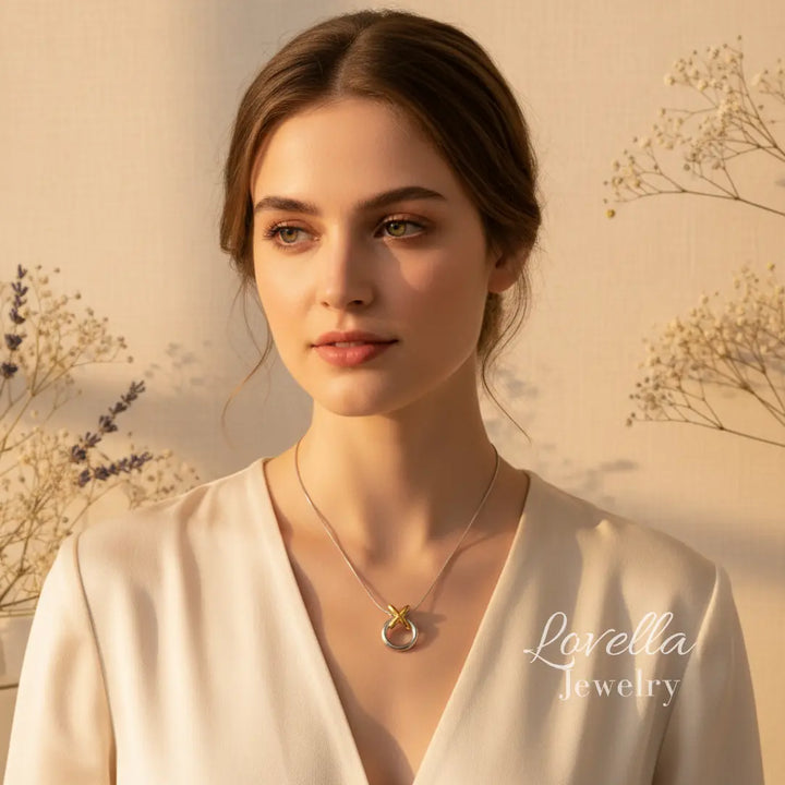 Woman wearing a necklace with a soft background and 'Lovella Jewelry' branding.