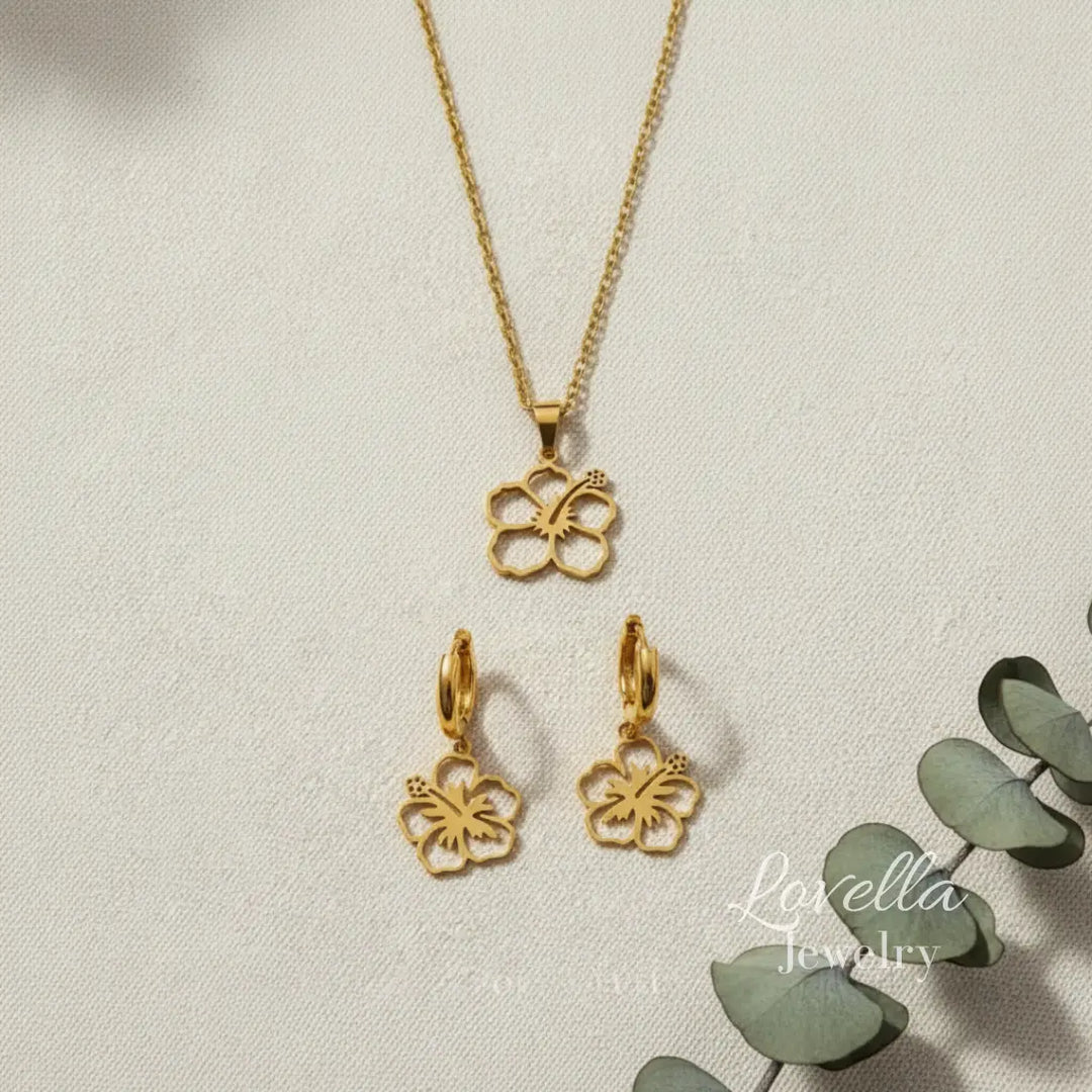 Gold butterfly necklace and earrings on a light background with 'Lovella Jewelry' branding.