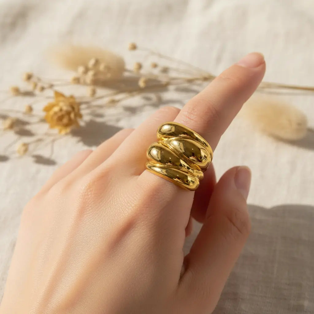 Gold ring on a finger with a soft background