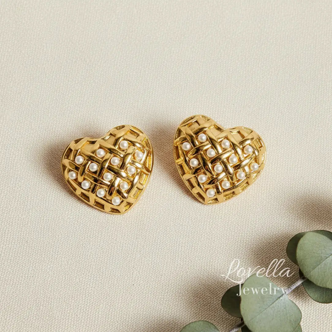 Gold heart-shaped earrings with pearl detailing on a beige background, branded 'Lavella Jewelry'.