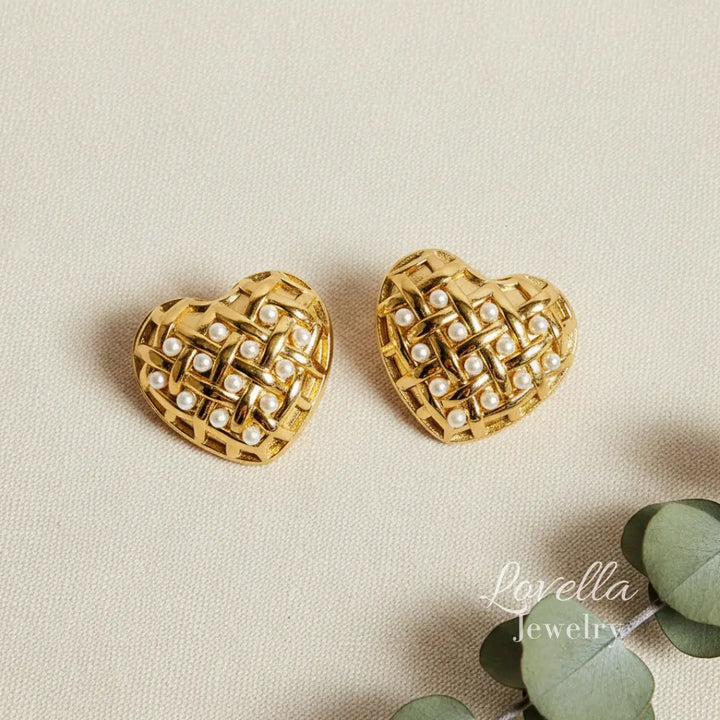 Gold heart-shaped earrings with pearl detailing on a beige background, branded 'Lavella Jewelry'.