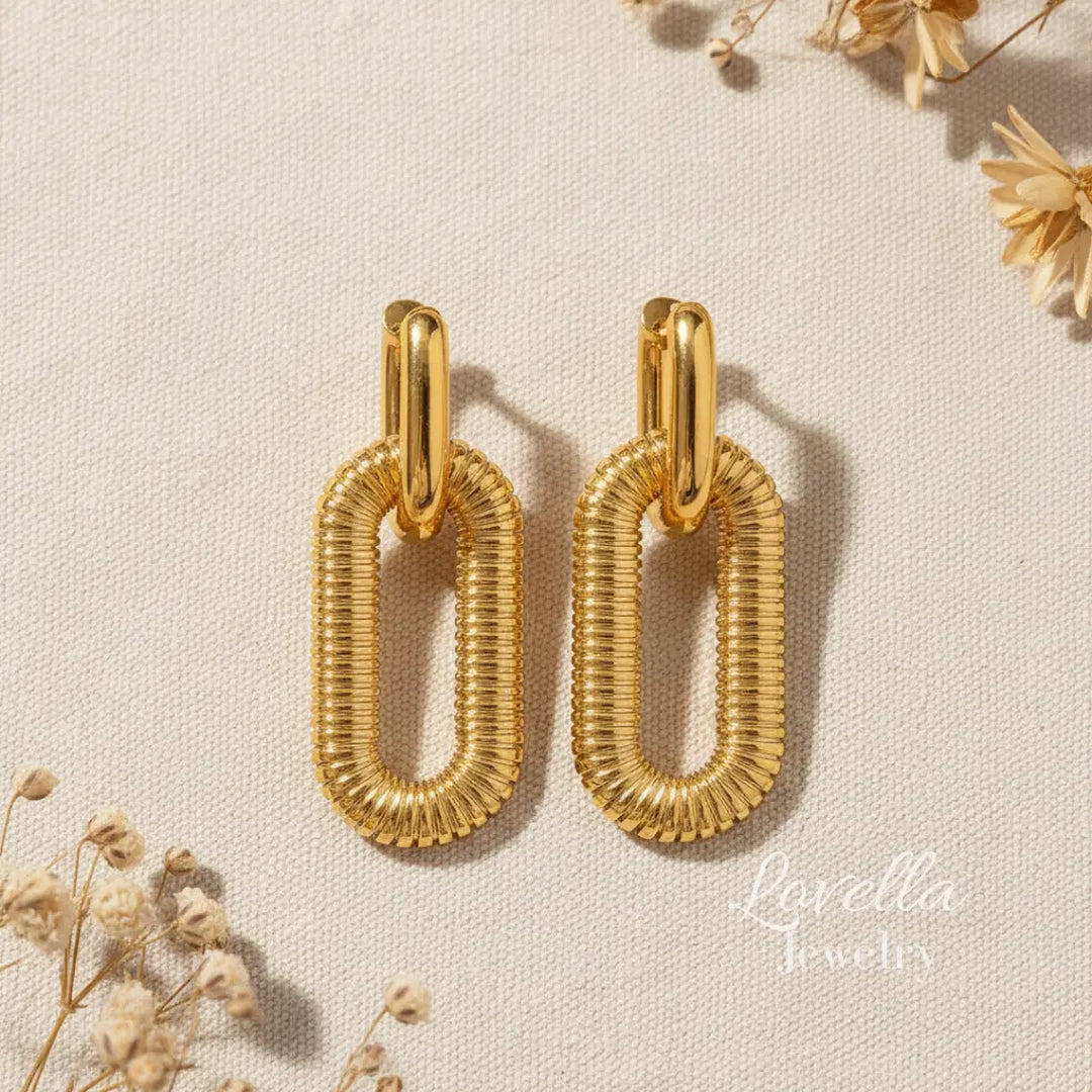 Gold hoop earrings on a beige background with 'Lovella Jewelry' branding.