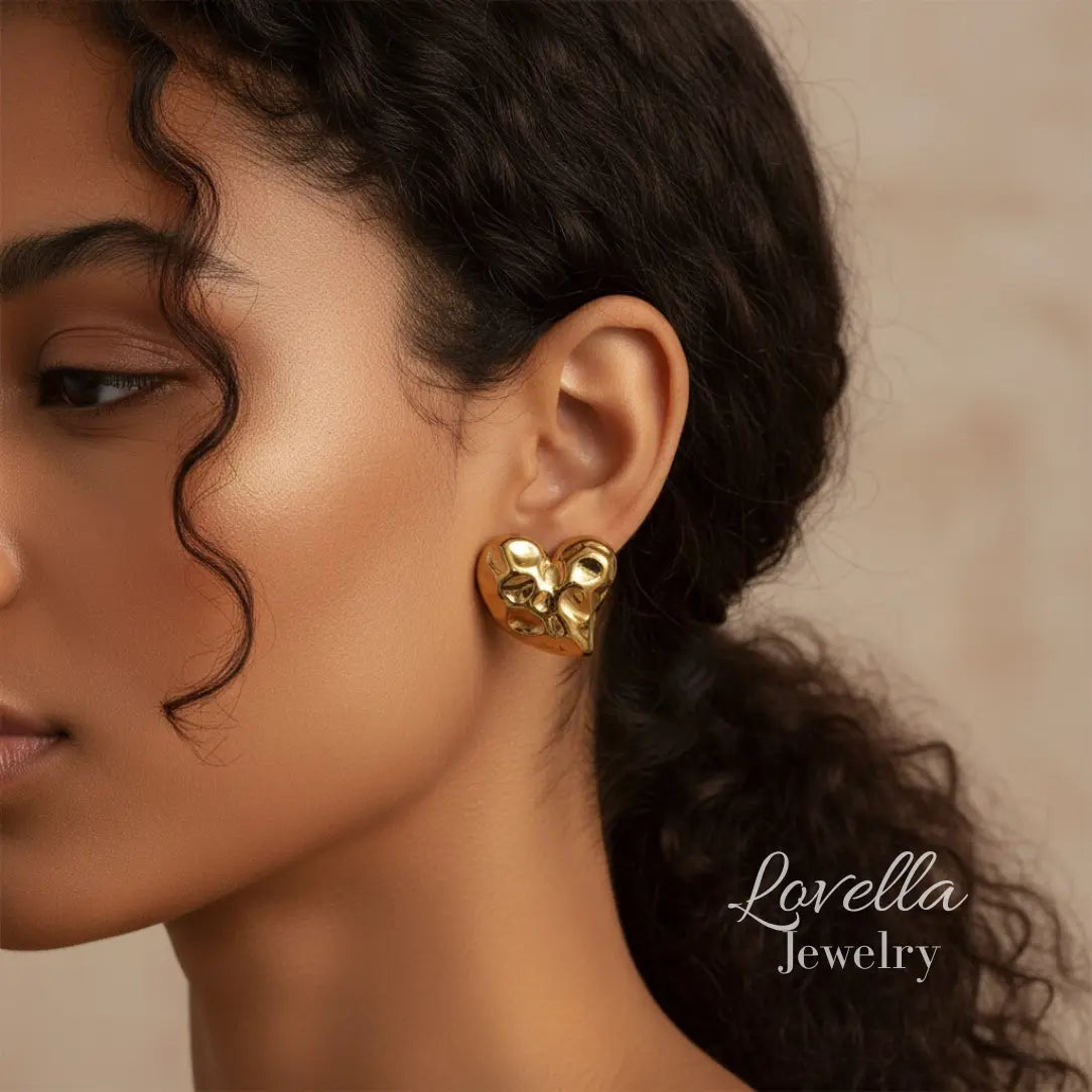 Close-up of a woman wearing gold earrings with 'Lovella Jewelry' branding.