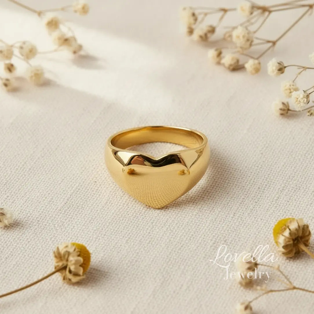 Puffy heart dome ring in gold 316 stainless steel on linen background