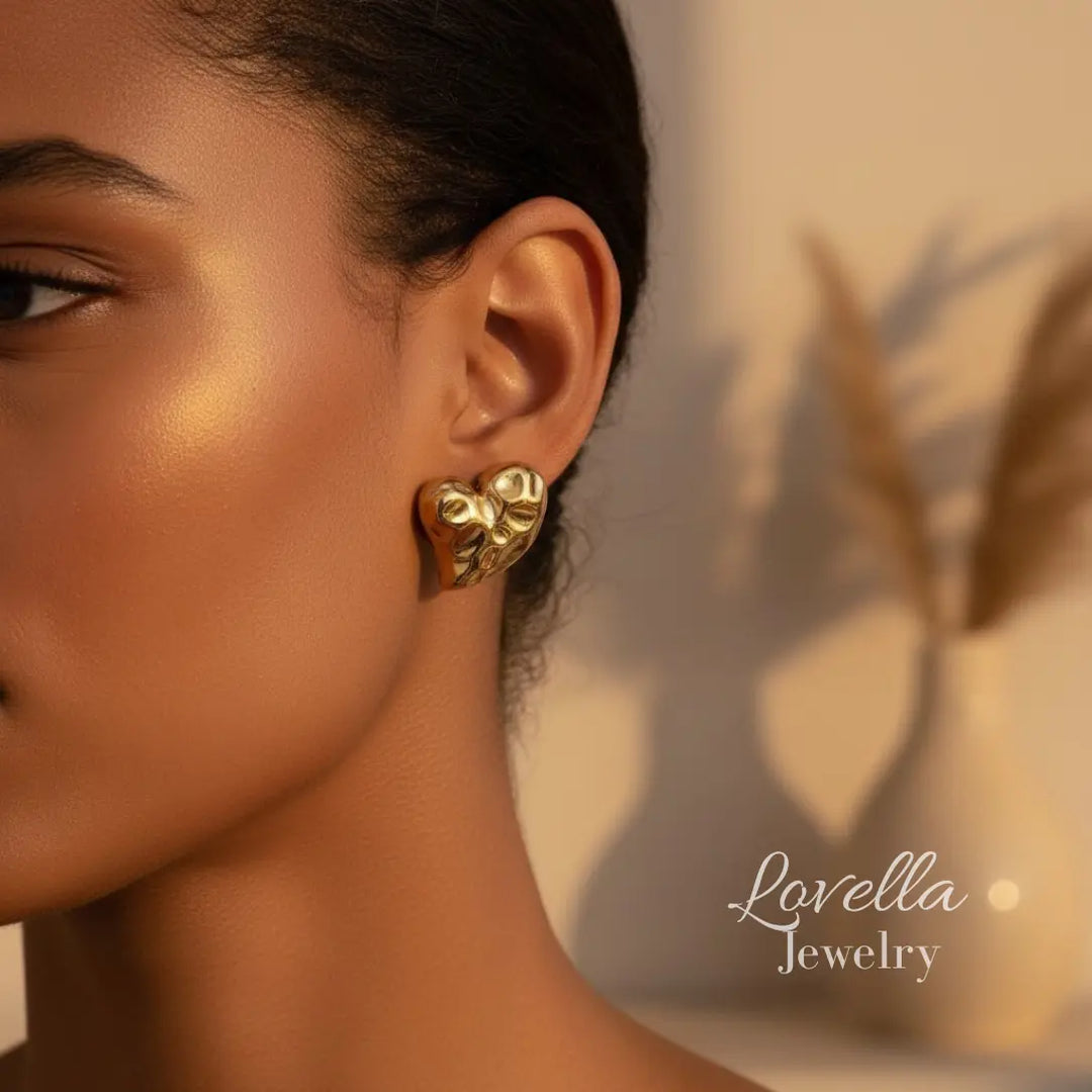 Close-up of a woman wearing gold earrings with 'Lovella Jewelry' branding.