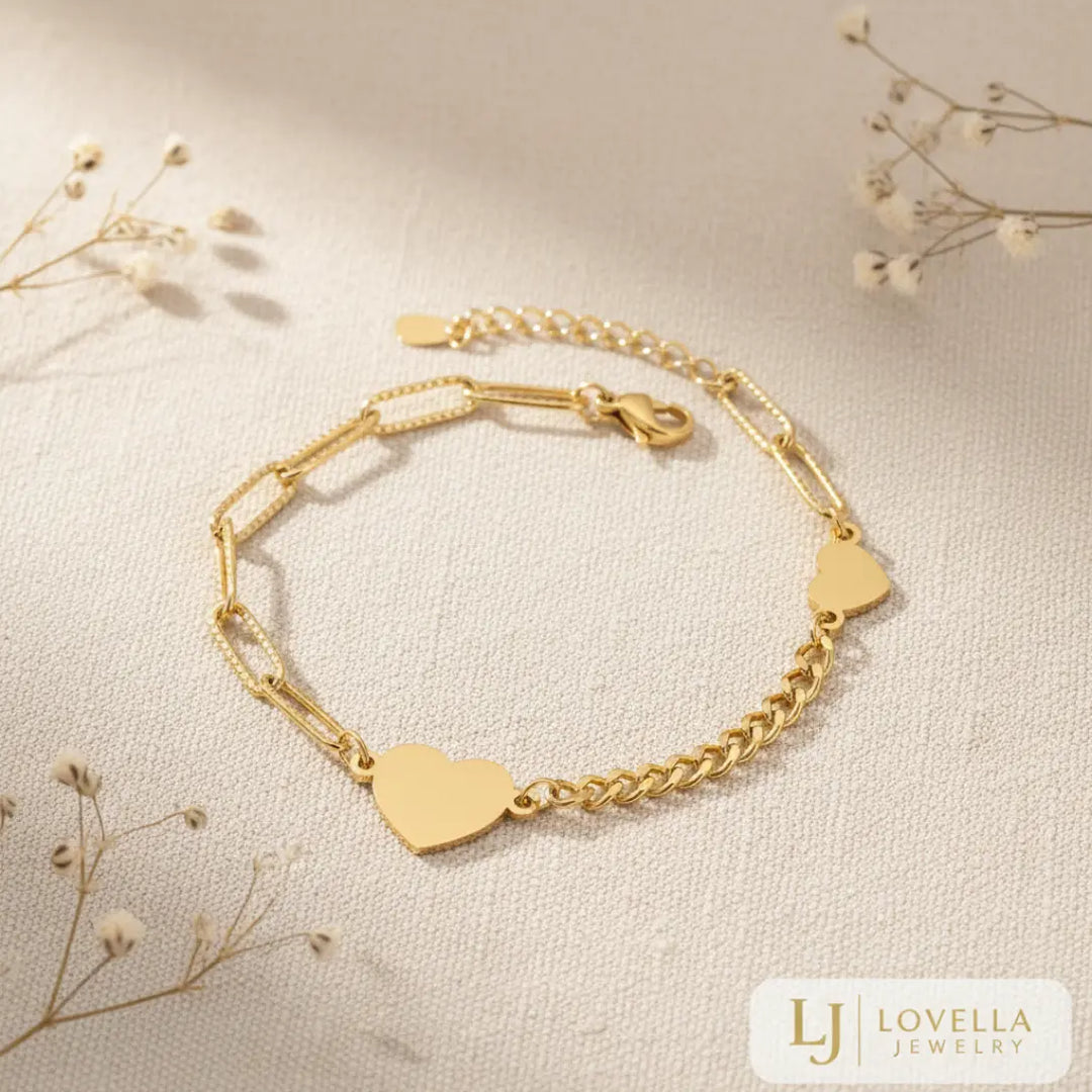Gold bracelet with heart-shaped charms on a light background, featuring Lovella Jewelry logo.
