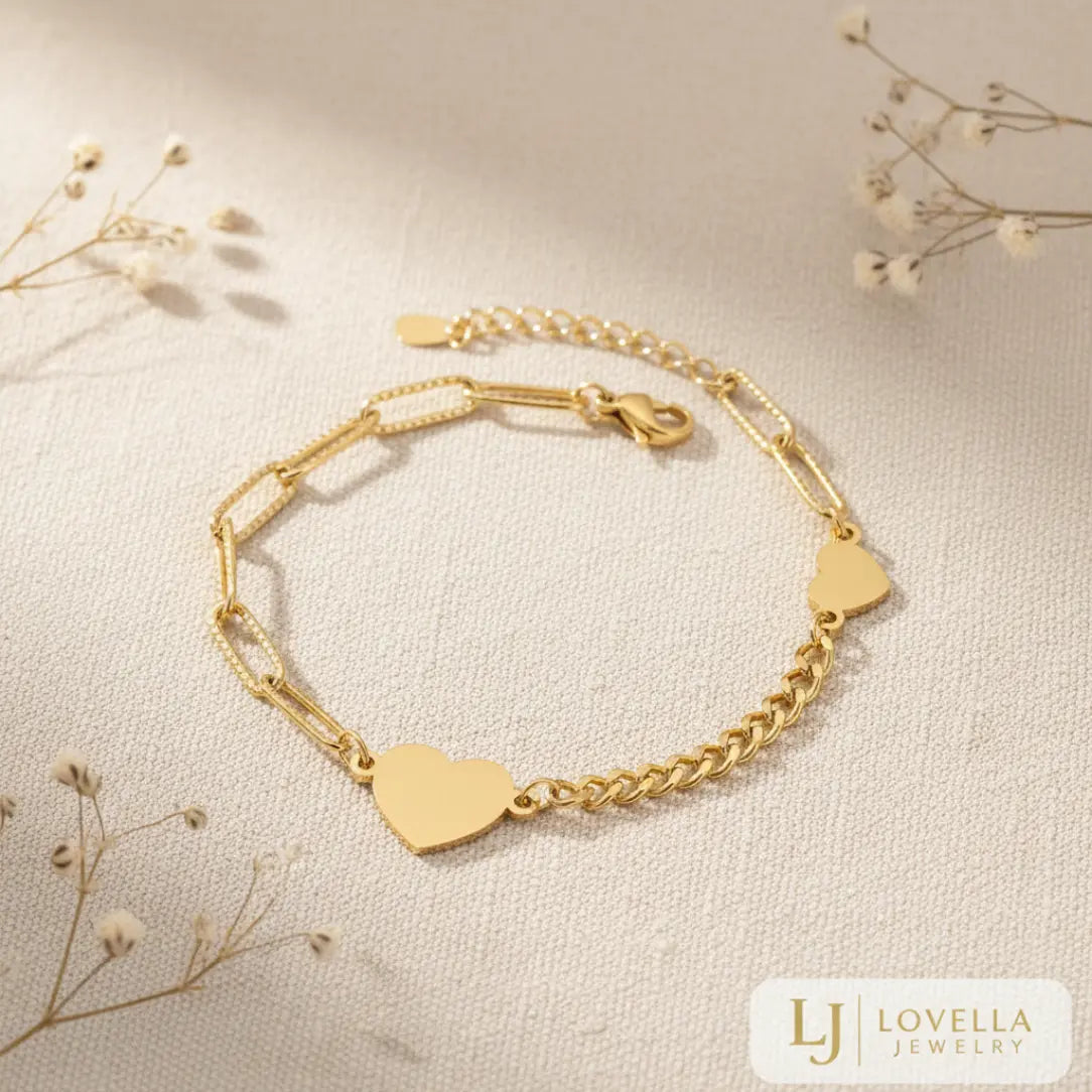 Gold bracelet with heart-shaped charms on a light background, featuring Lovella Jewelry logo.