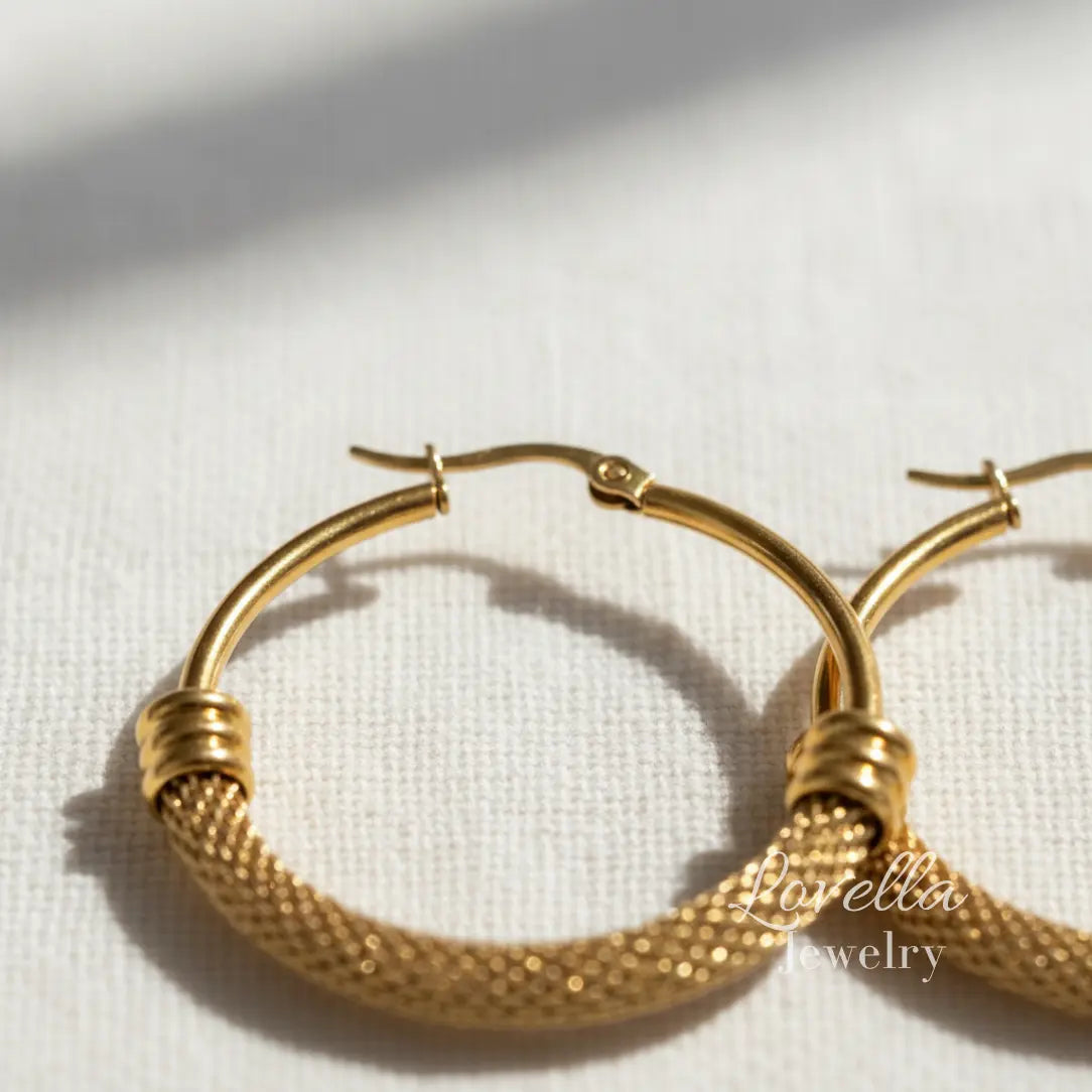 Gold mesh hoop earrings with polished accents, 25mm diameter, click closure, high-polish finish.