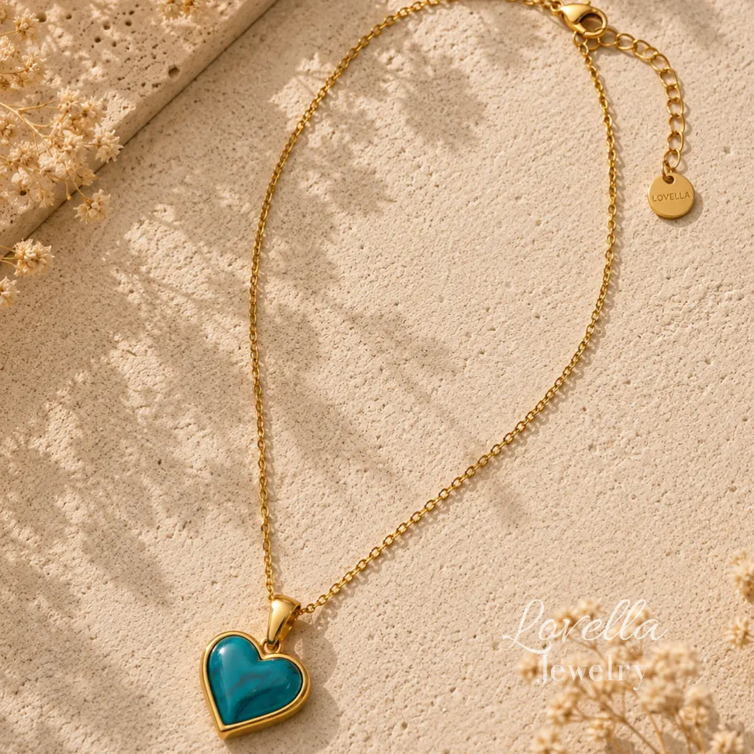 Amore Heart Necklace in turquoise with gold-plated chain styled on warm cream stone