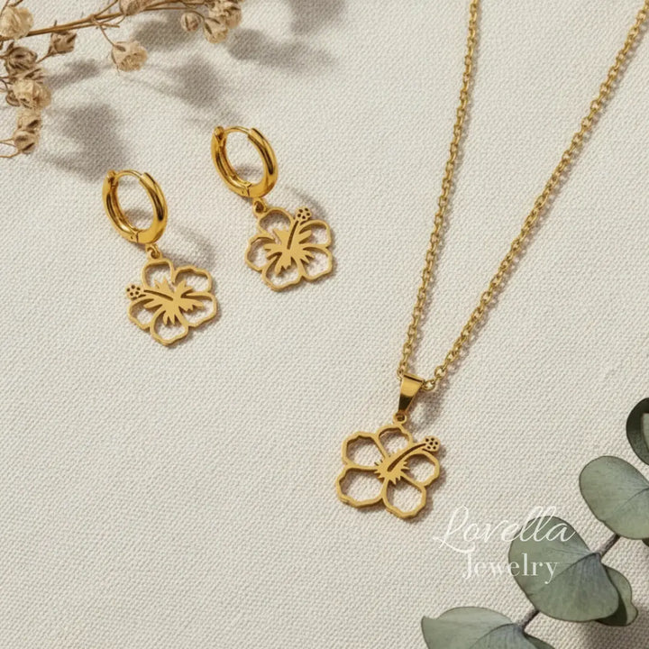Gold butterfly necklace and earrings on a light background with 'Lovella Jewelry' branding.