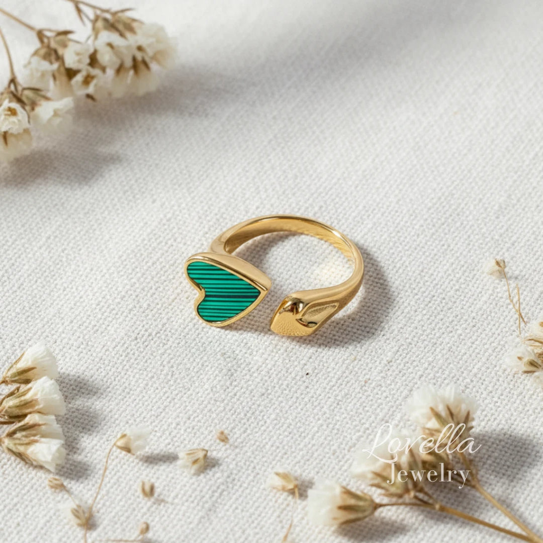 Flat lay of striped heart enamel ring with high-polish gold finish