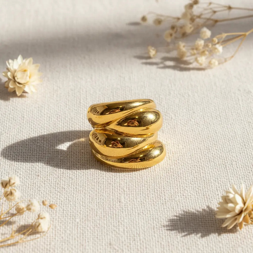 Gold ring on a light background with dried flowers