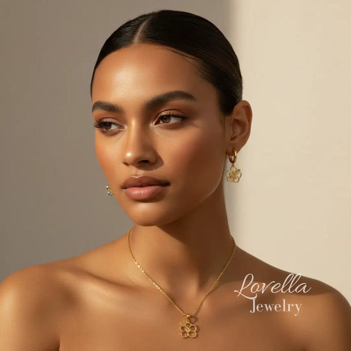 Woman wearing gold jewelry with 'Lovella Jewelry' branding on a neutral background