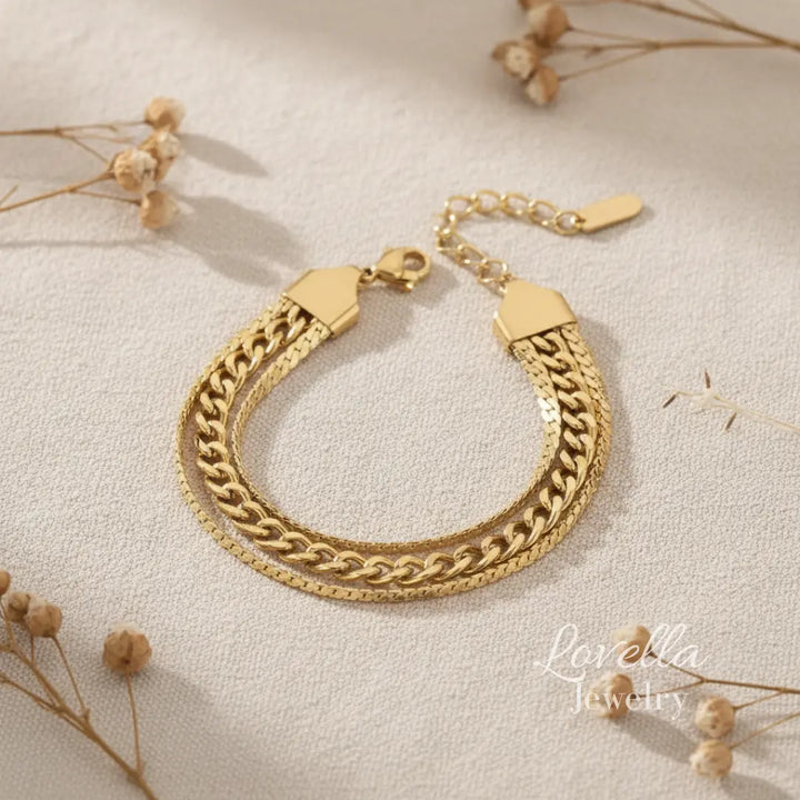 Gold chain bracelet on a light background with dried flowers